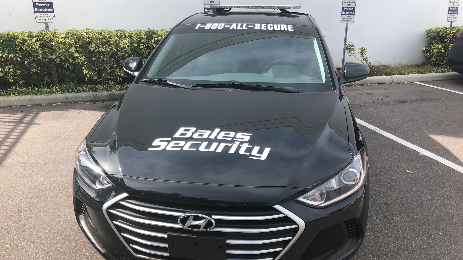 Bales Security work car displayed in parking lot in Brandon, FL.