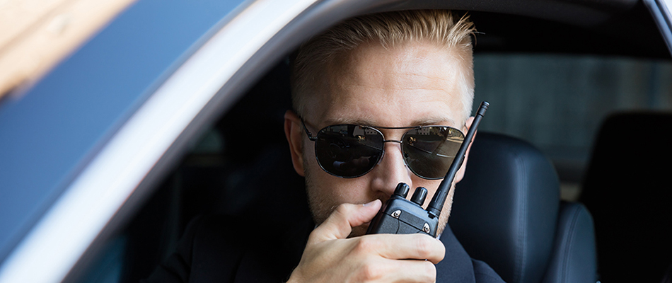 Private investigator talking on a radio in Tampa, FL. 